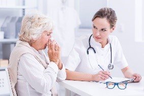 mold testing Female medical doctor and female patient sitting at table.